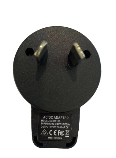 A close-up of a black AC/DC adapter plug with two prongs, resembling the 5V USB Adaptor Plug for Deluxe Electric Dog Fence by Pet Control HQ. The label reads model L30NS100, with an input of 100V-240V and an output of 5V=1000mA, and includes certification marks. Made in China.